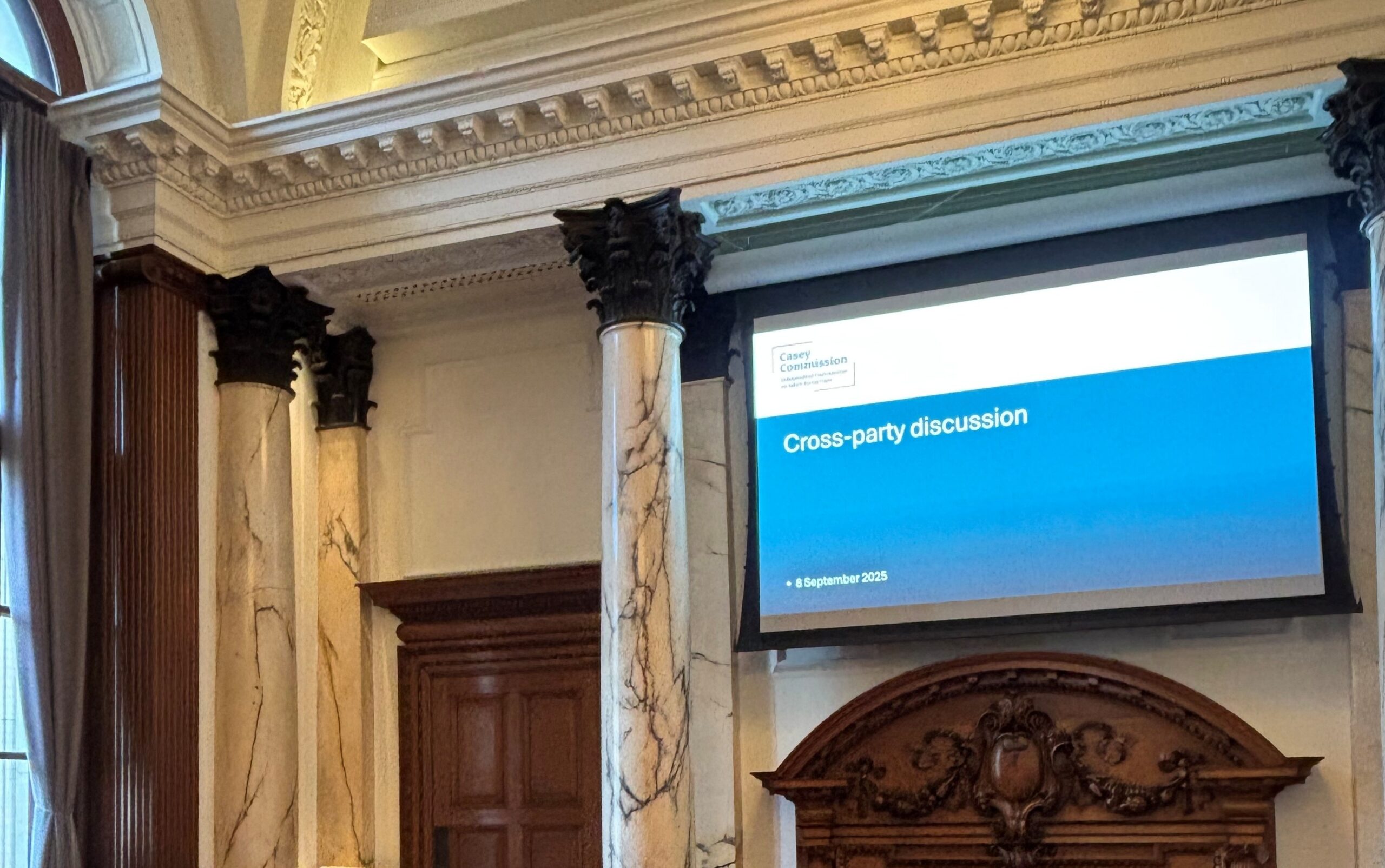 Photograph of a projector screen at a cross party discussion event